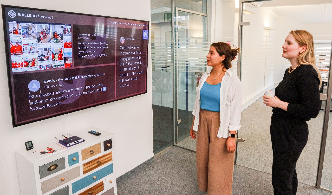 Commercial leads reviewing digital analytics and data tracking displays to measure impact under the social value model.   