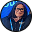 Smiling woman with glasses holding a credit card and a smartphone in front of a blue background.