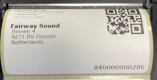 Close-up photo of a printed shipping label for Fairway Sound in the Netherlands with barcode and QR code.