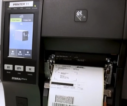 Photo of a label printer printing a parcel shipping label.