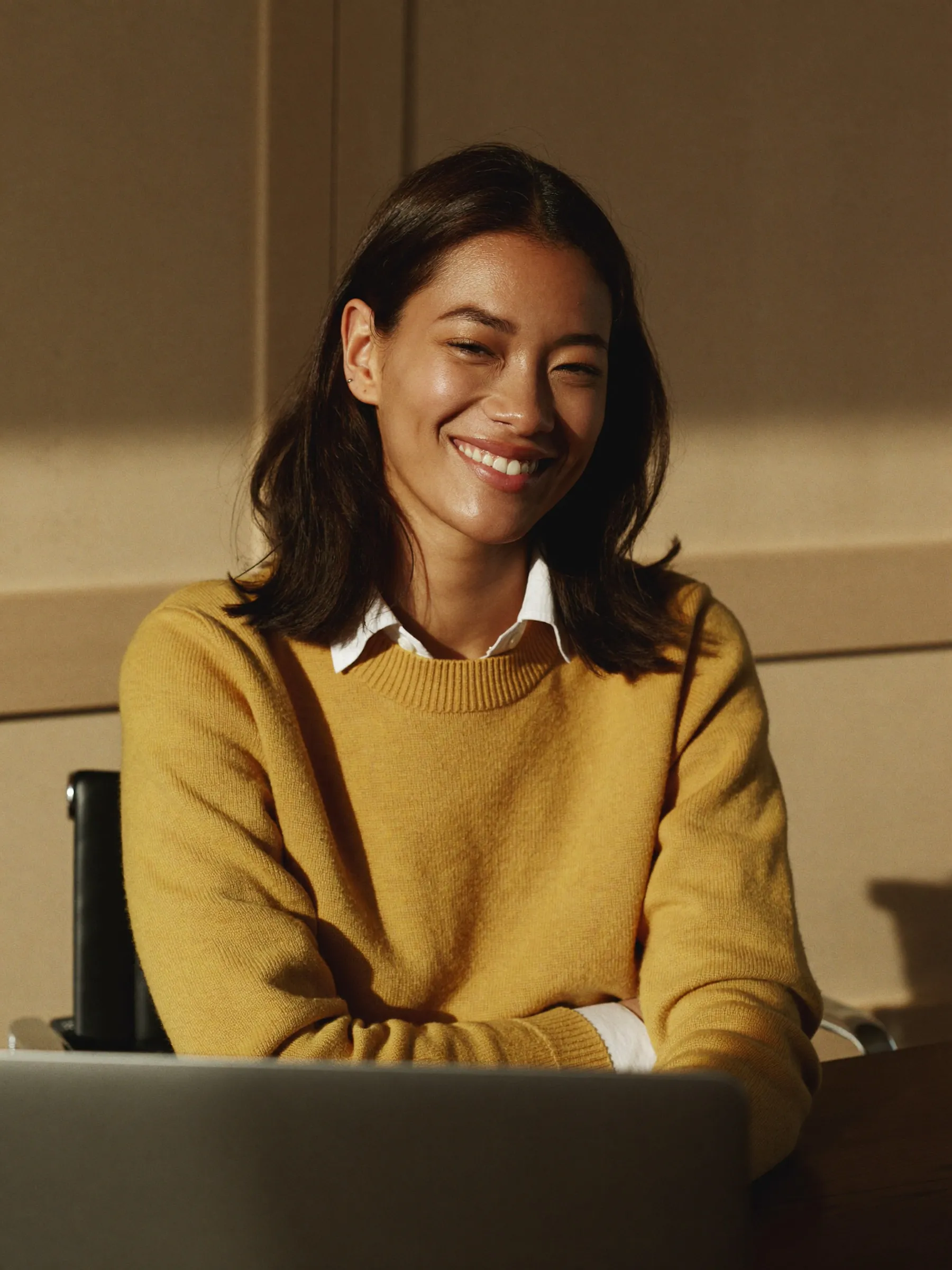 A woman sitting in front of a laptop computer.