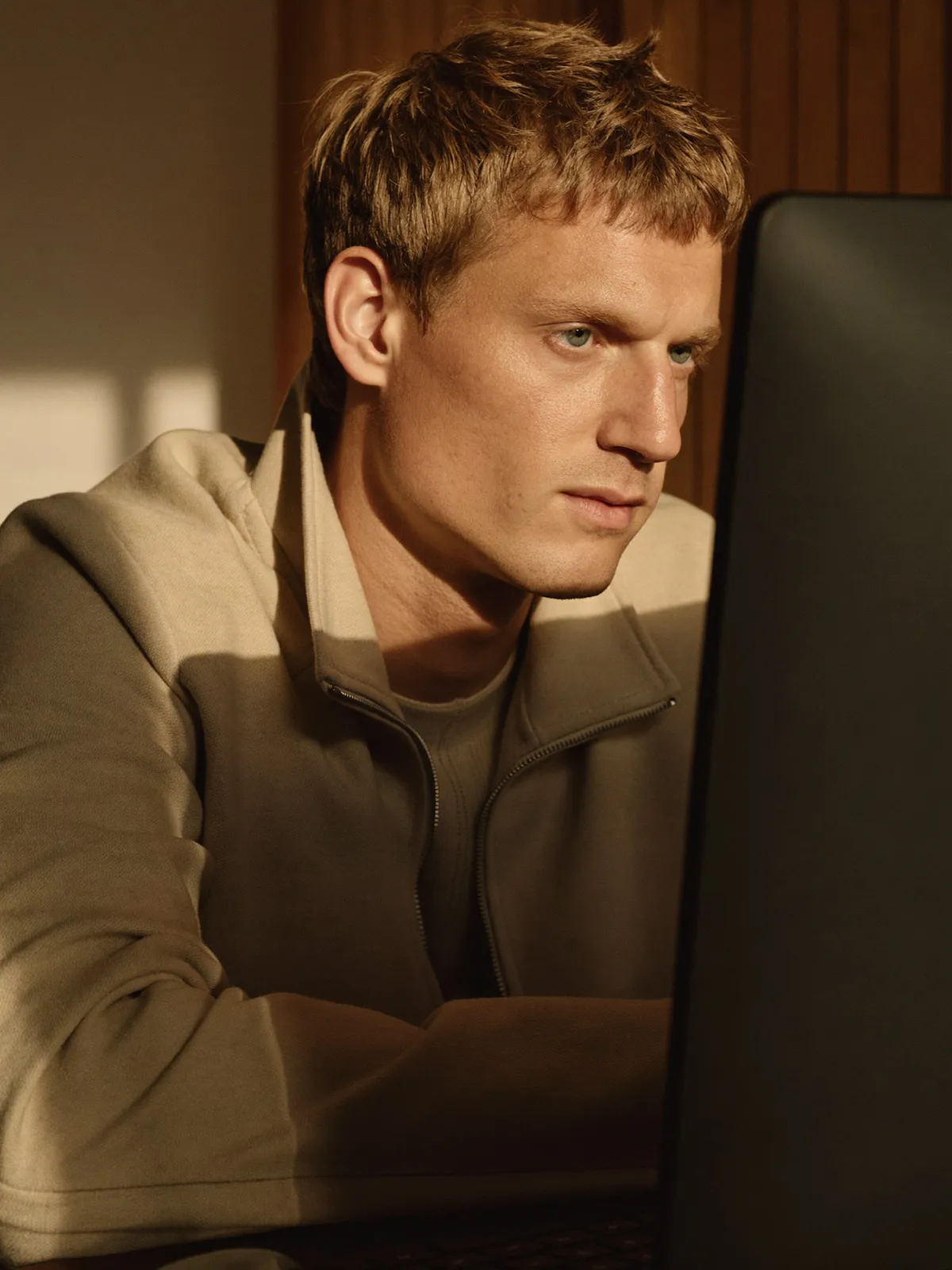 A man sitting in front of a laptop computer.