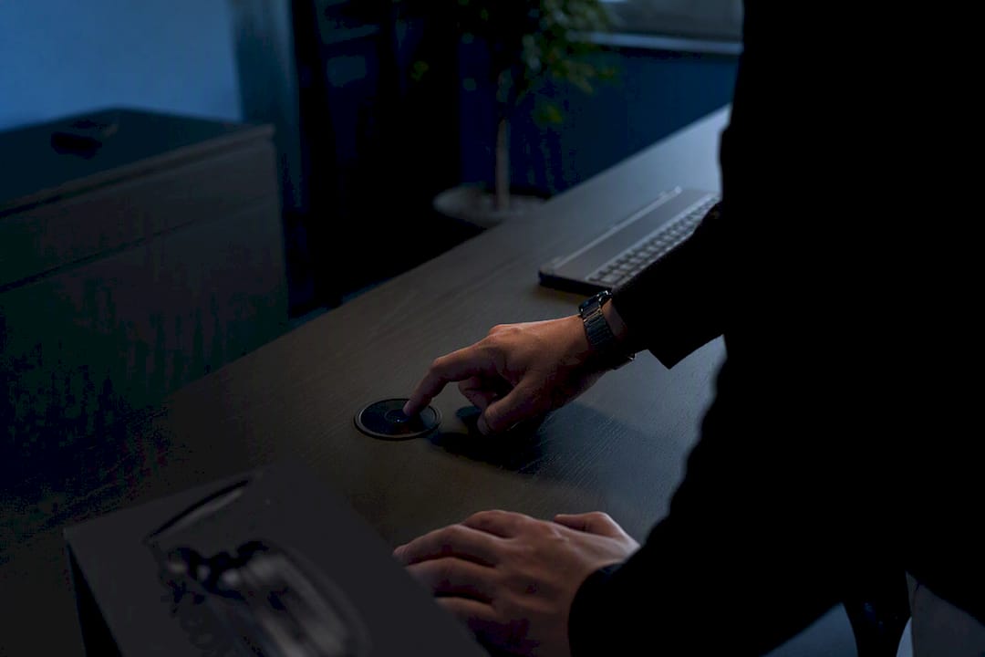 Hands pressing button on minimalist desk