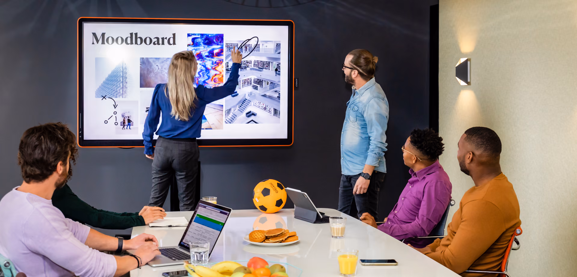 A team using the final product in a meeting about interior architecture designs