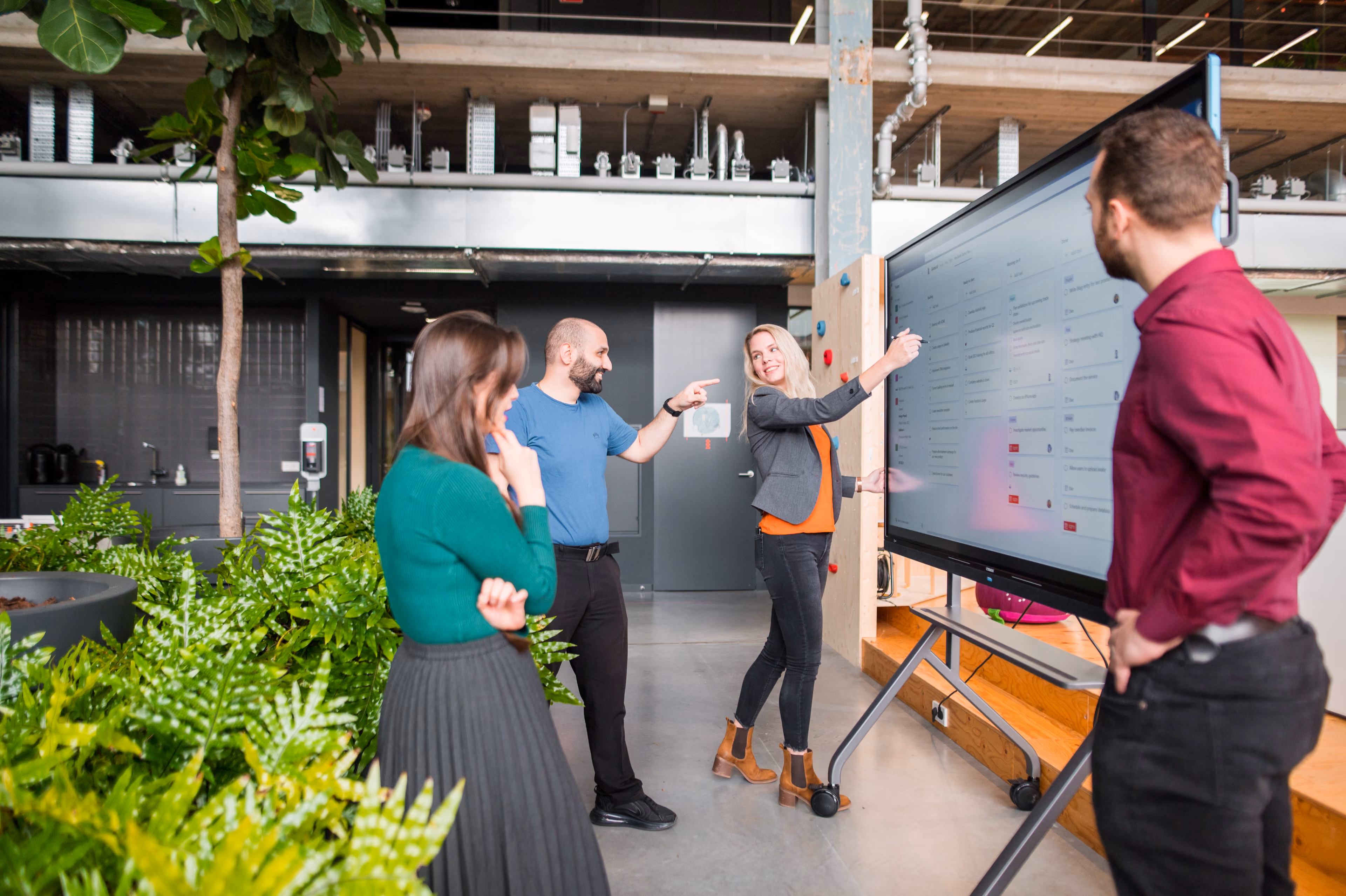 A woman annotates on an interactive planning board on a CTOUCH Neo