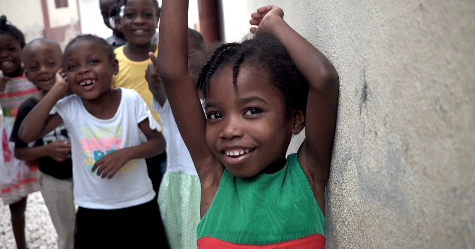 Smiling children playing together in a community setting
