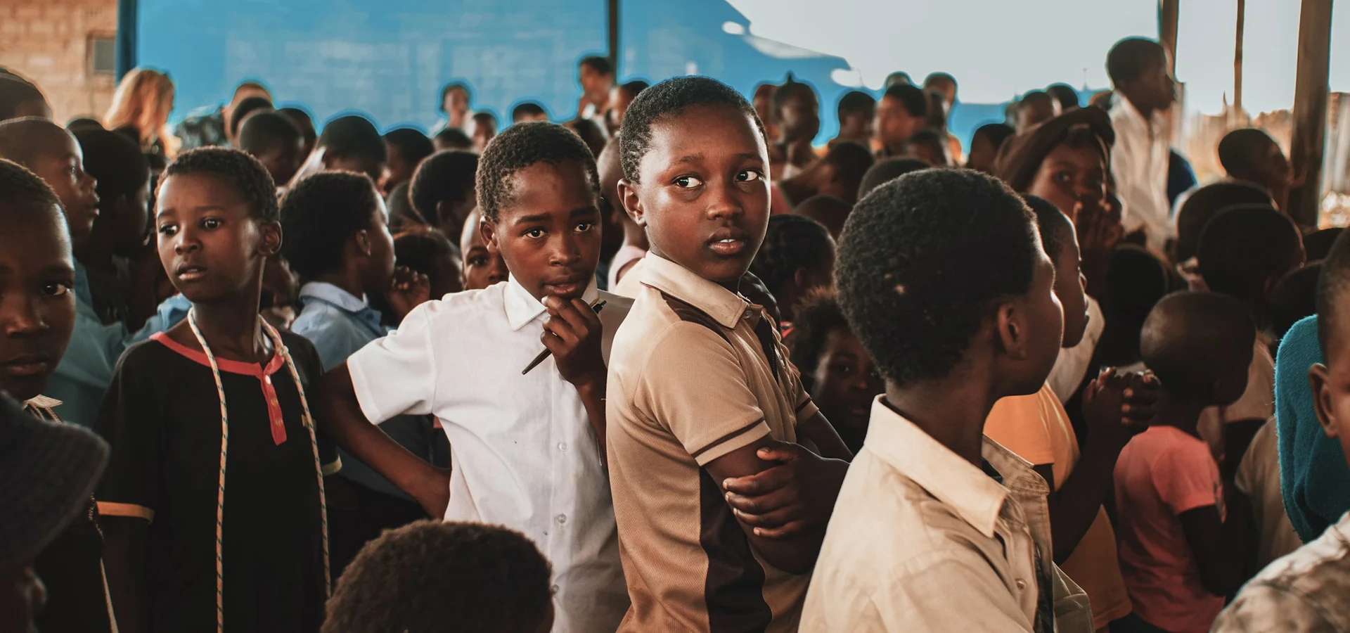 Large group of students in uniforms gathered at a school assembly