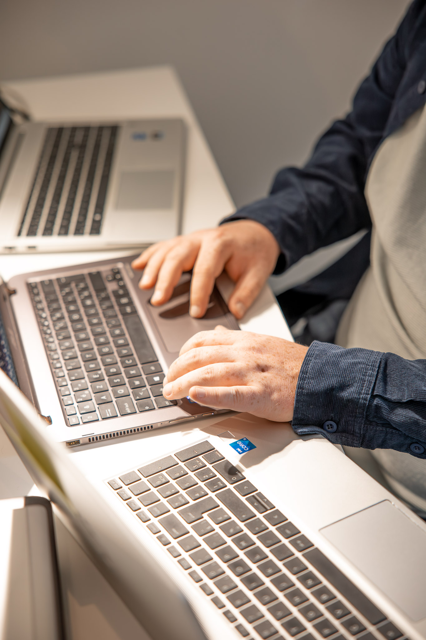 Person working on a laptop with coffee