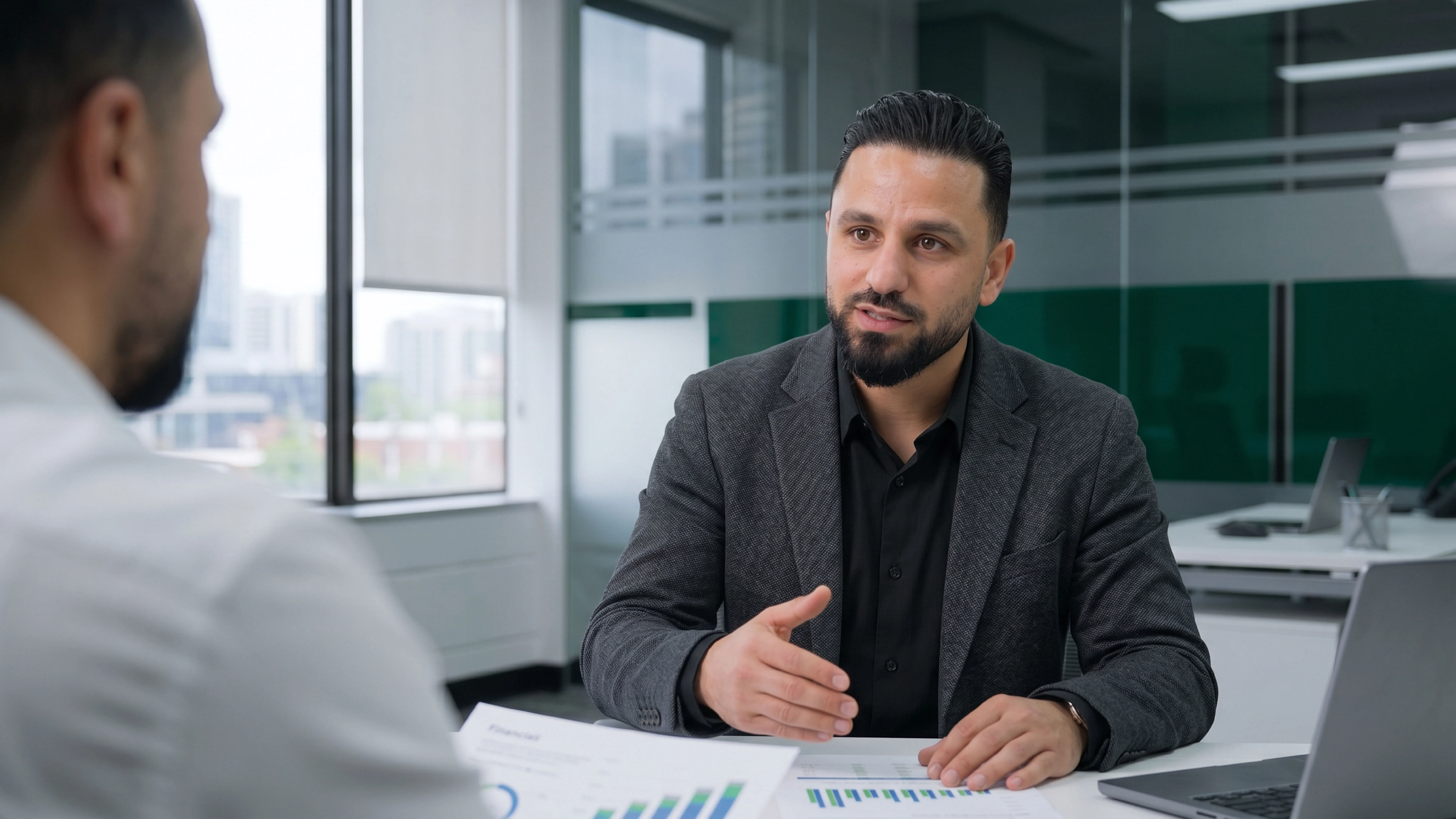 Taxperts advisor discussing financial reports with a client at a conference table