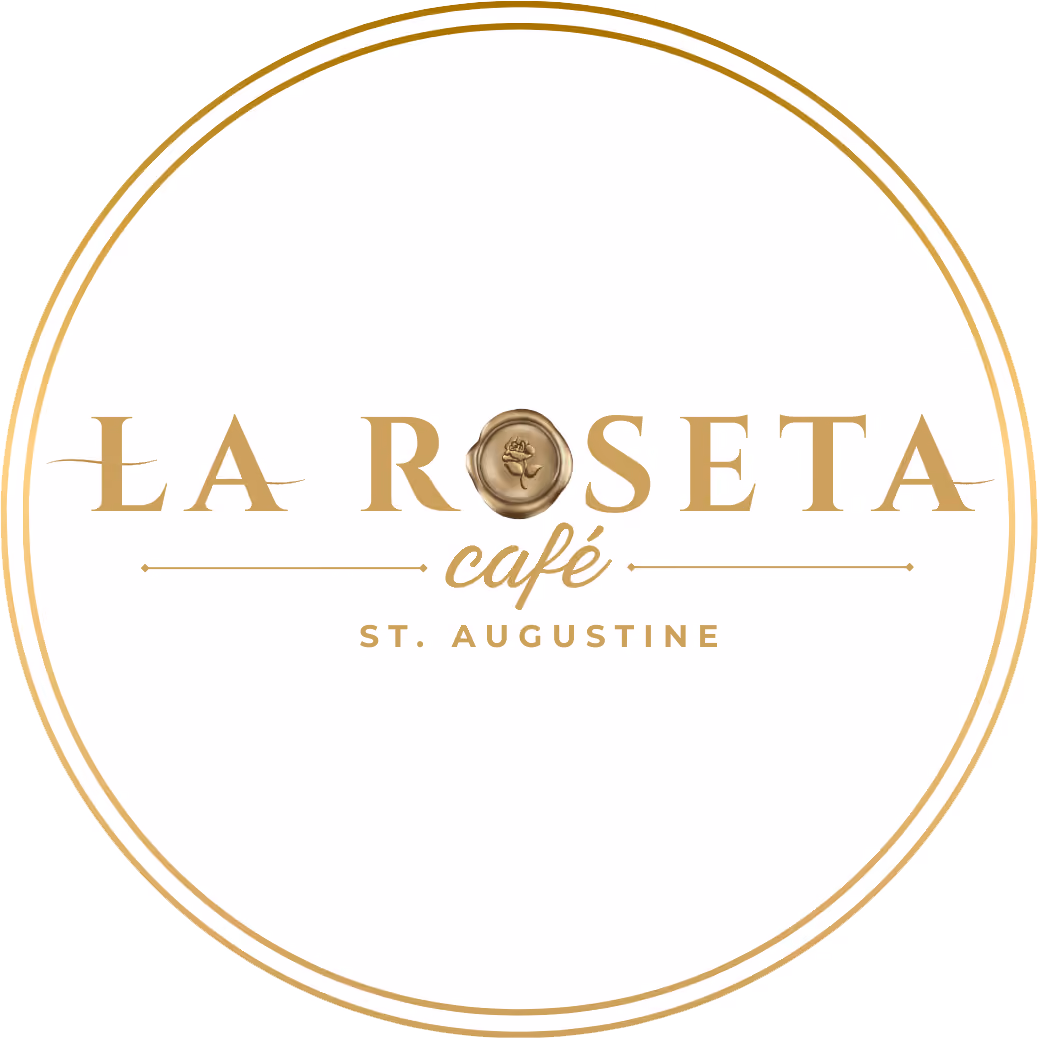 Circular gold emblem with text La Roseta café St. Augustine and a rose wax seal in the center