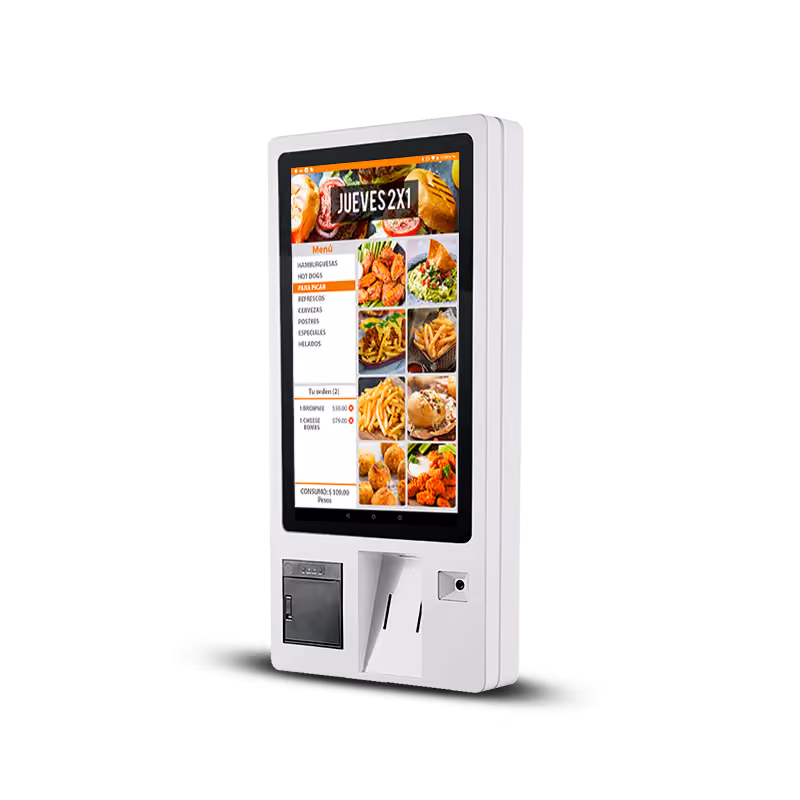White self-service kiosk with a touchscreen displaying a food menu featuring items like hamburgers, hot dogs, fries, and chicken wings, with a section for order summary and prices.