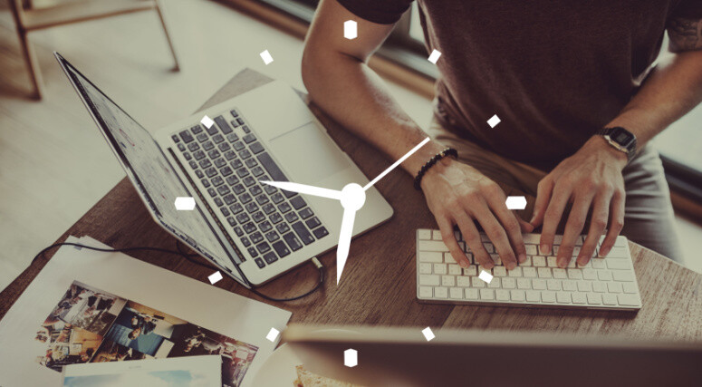 Clock superimposed over man at desk using keyboard