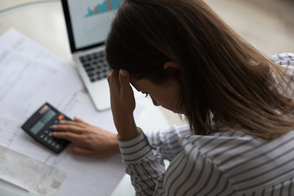 A business owner looks dejected as they review recent chargeback data. 