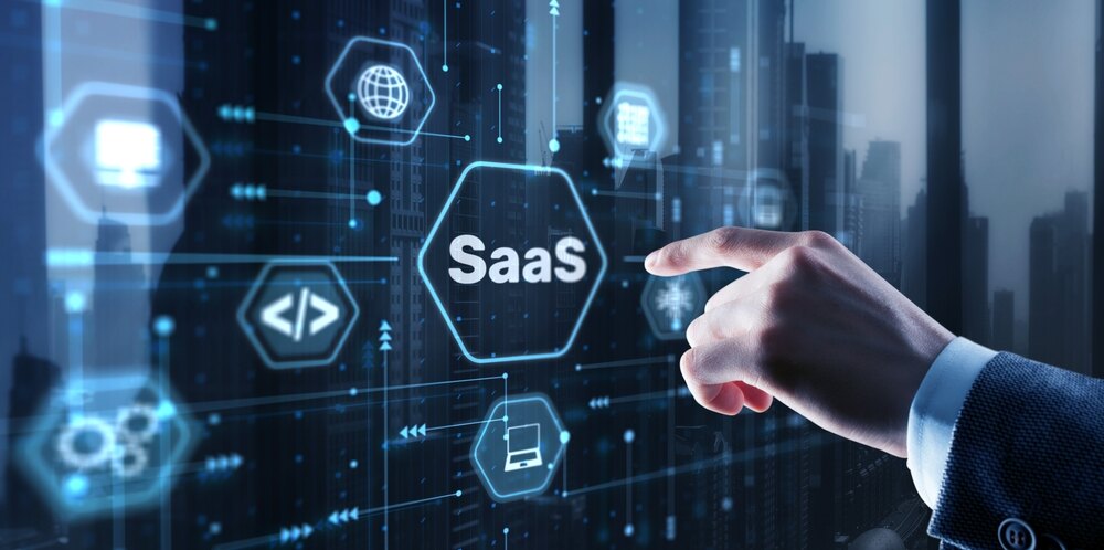 A hand reaches out to select a SaaS icon on a touchscreen. 