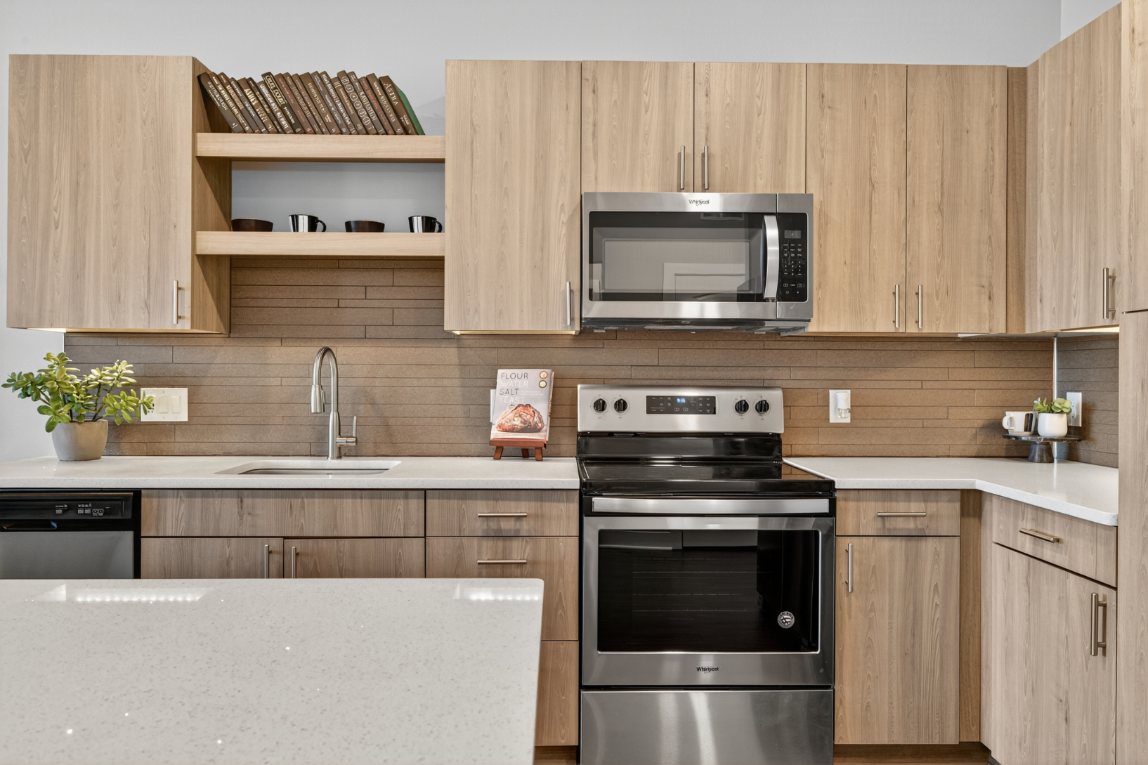 Kitchen with white counter tops and stainless steel appliances