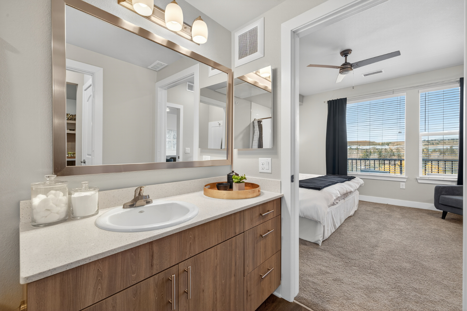Bathroom with vanity and view of bedroom
