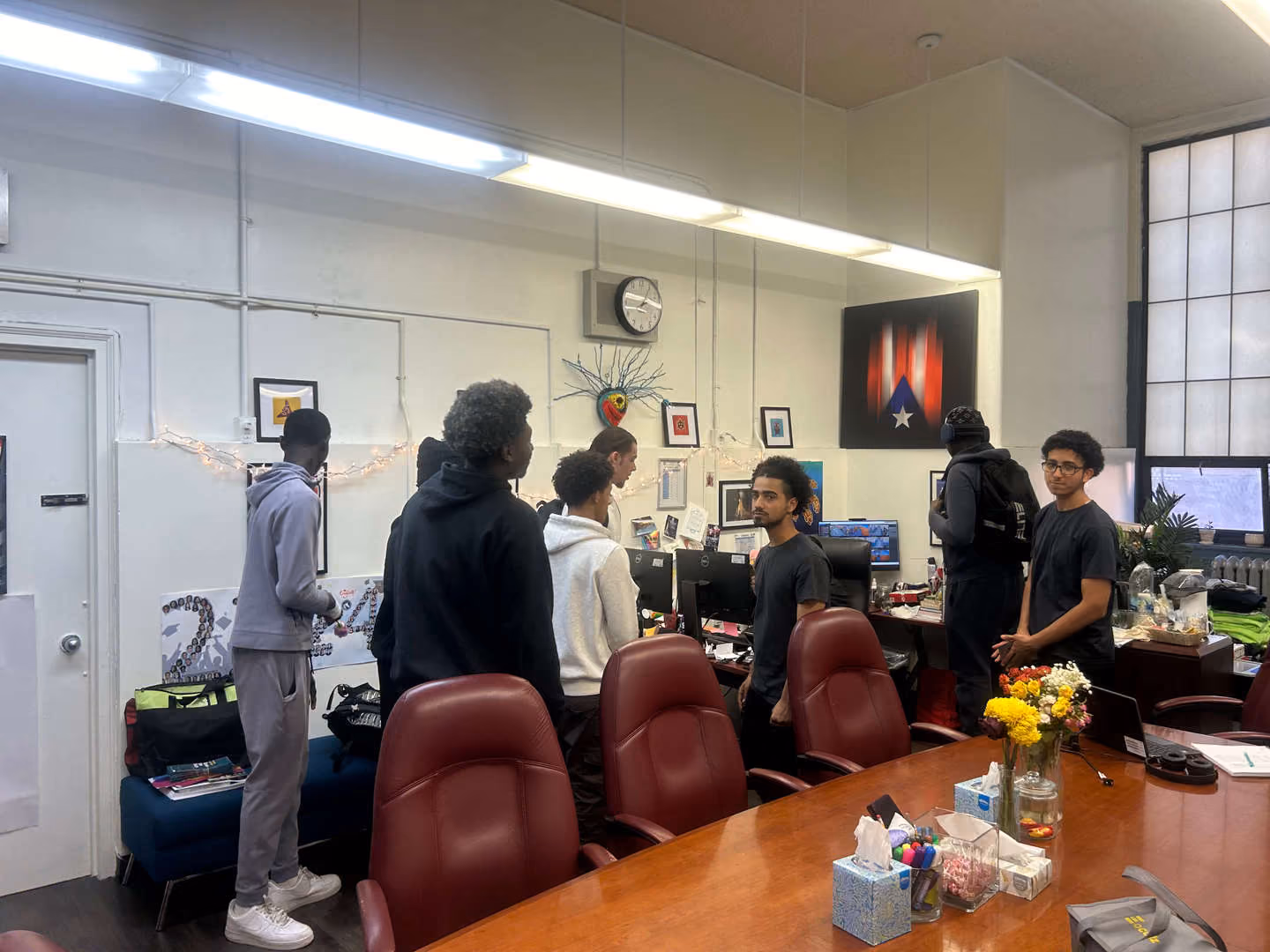 Students gathered around a desk in a school office