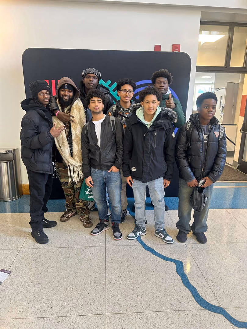 Students and chaperone posing together during a school field trip