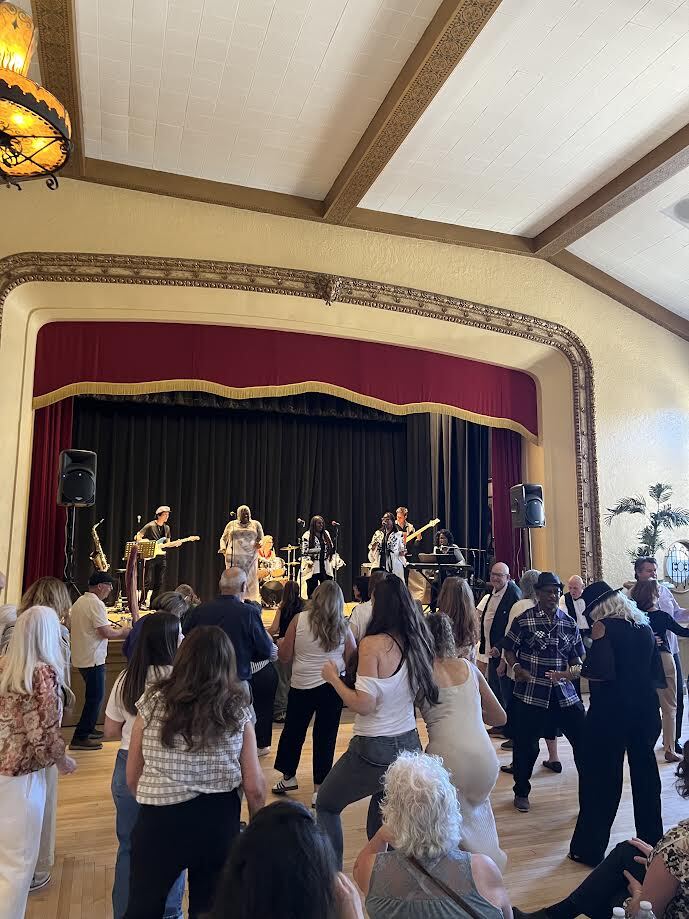 Guests dance near the stage as the band performs at Girls Got the Blues