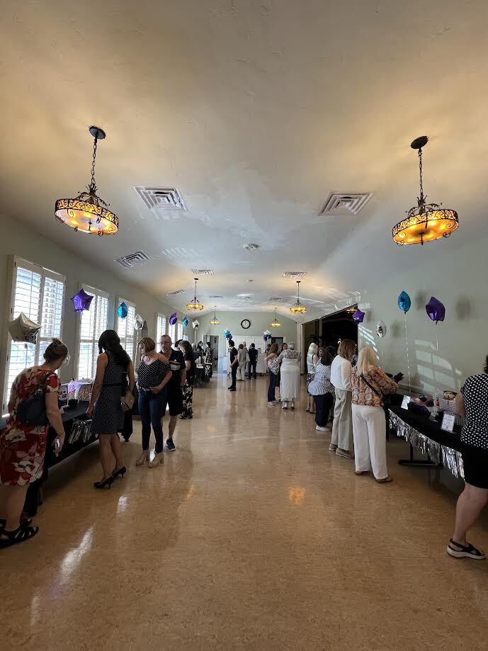 Guests mingle in the event hall at Girls Got the Blues