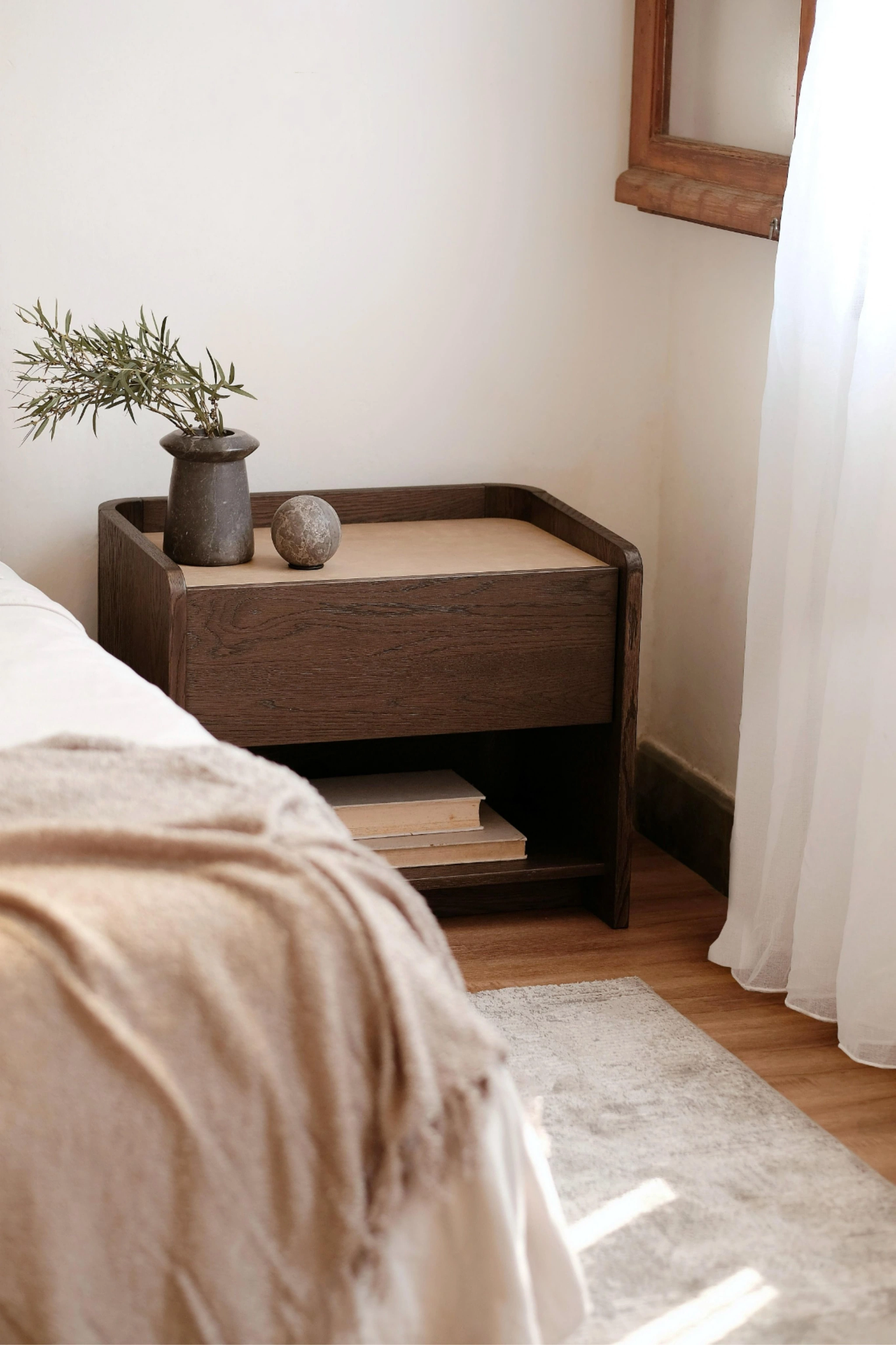 Solid nighstand on side of bed