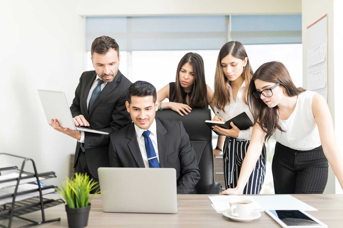 A legal support team reviewing case files together in a Connext office