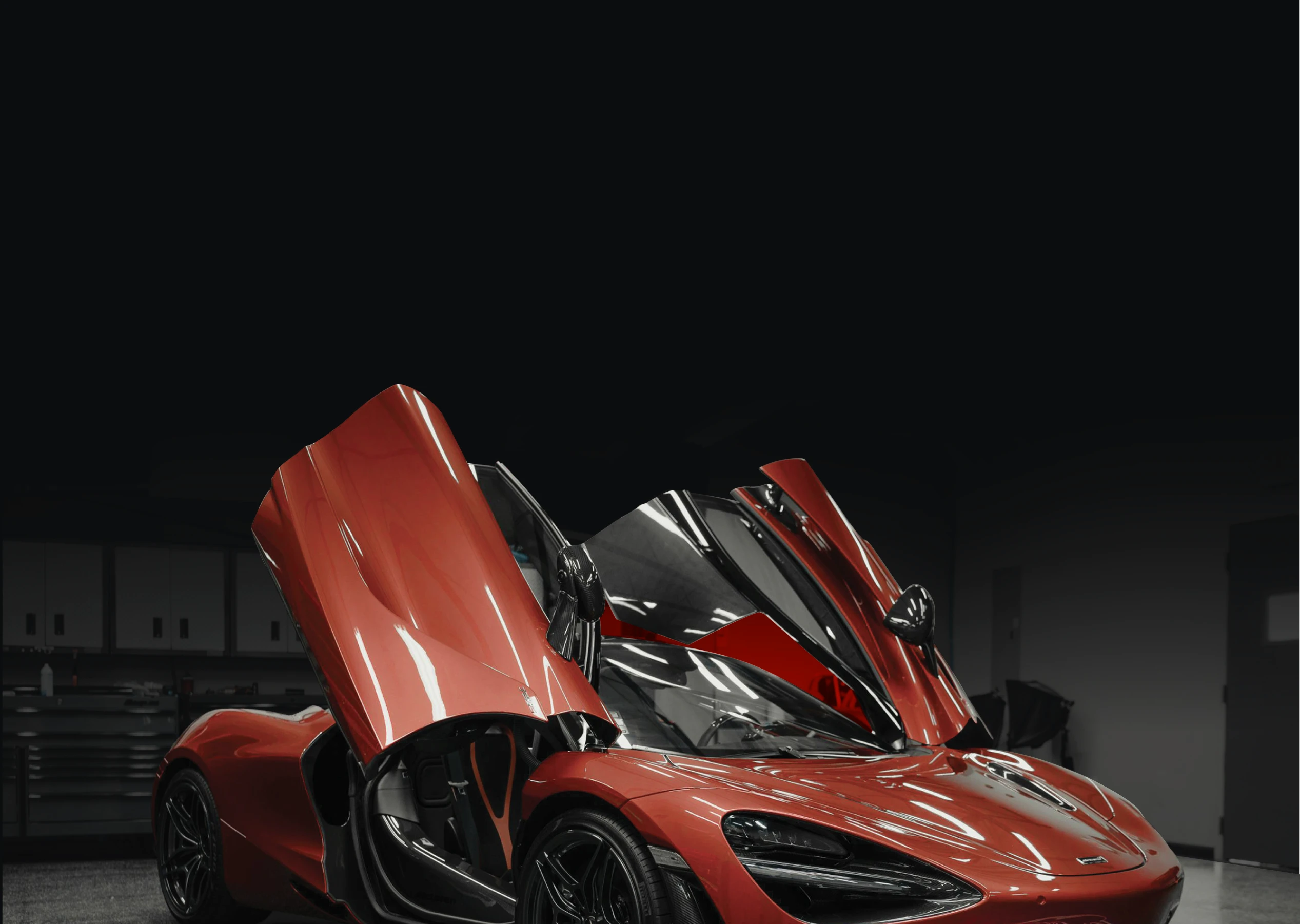 Rear view of a red car in an installation workshop