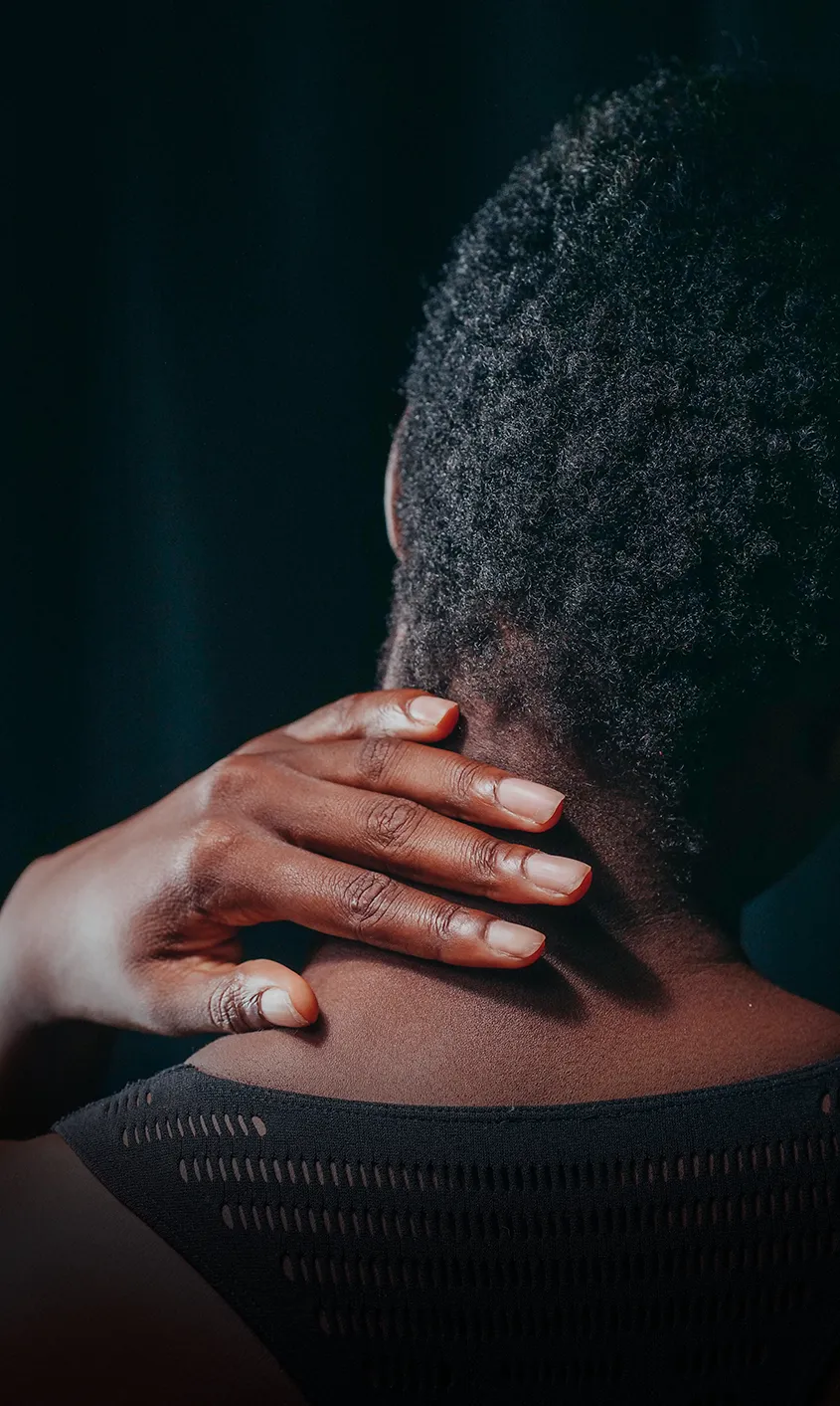 Woman dealing with neck and shoulder pain after being struck by a vehicle while a Rego Park hit by car attorney looks at how the pedestrian crash affected her recovery