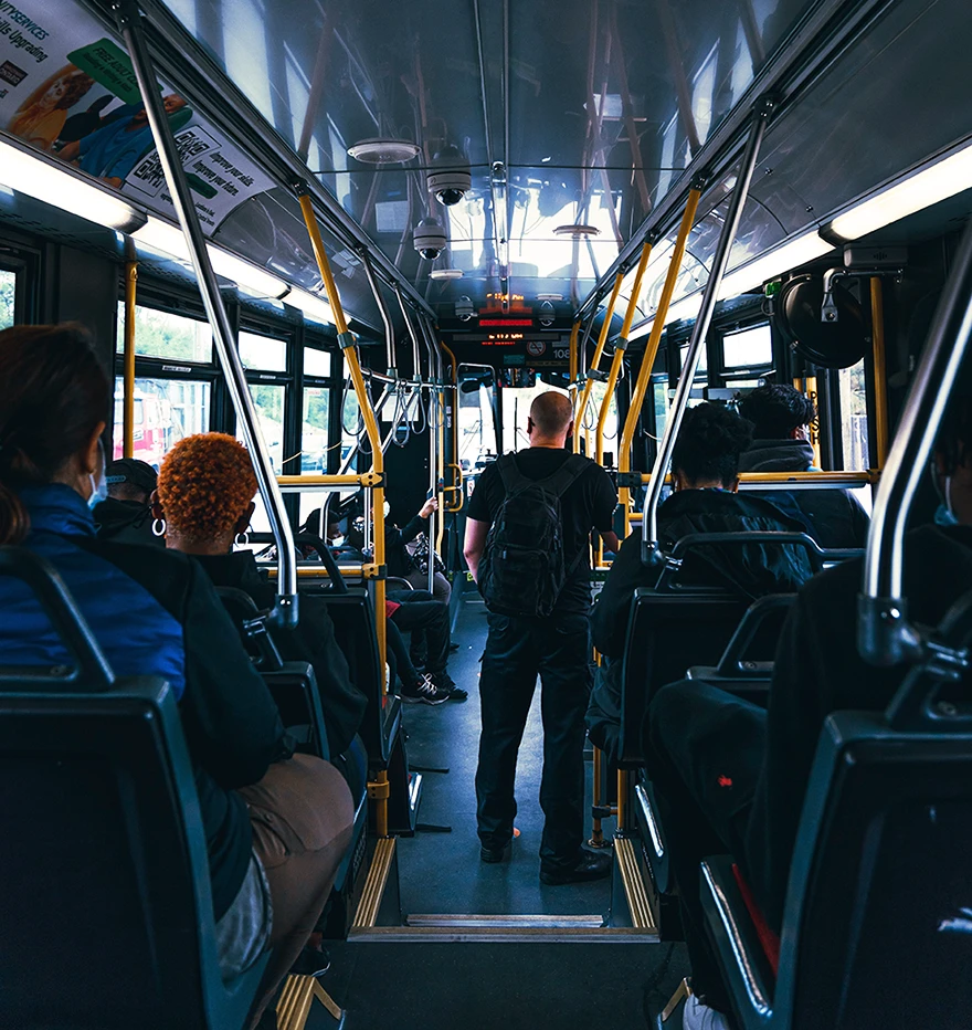Passenger standing inside a city bus before a sudden incident that may lead them to seek a Rego Park bus injury attorney