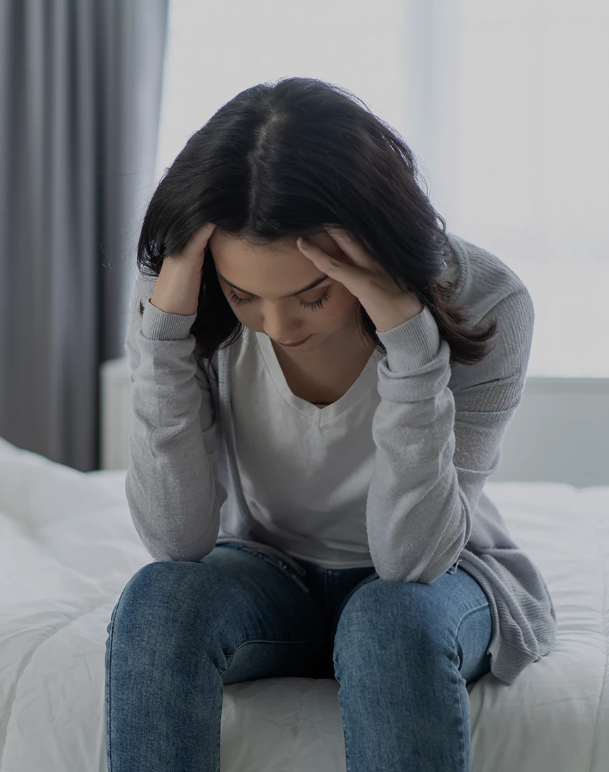 Woman feeling uncertain before signing divorce papers and deciding to speak with an uncontested divorce lawyer in Rego Park, Queens