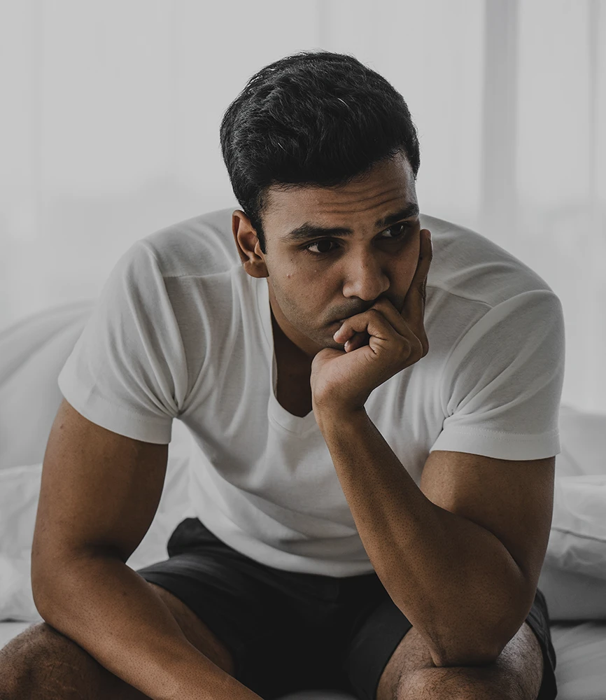 Father thinking through the financial pressure of supporting his child before speaking with a Rego Park child support lawyer about his options