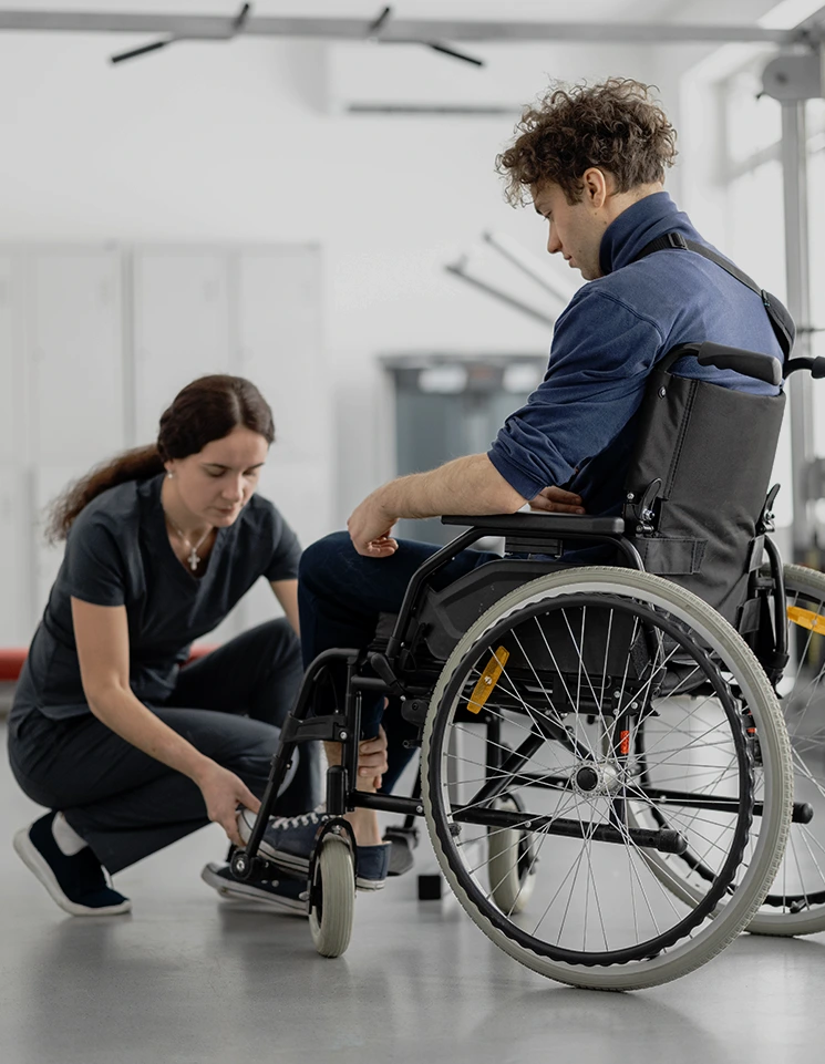 Person using a wheelchair during rehabilitation after a life changing injury while a Rego Park catastrophic injury lawyer helps address the long term effects on mobility, independence, and future care