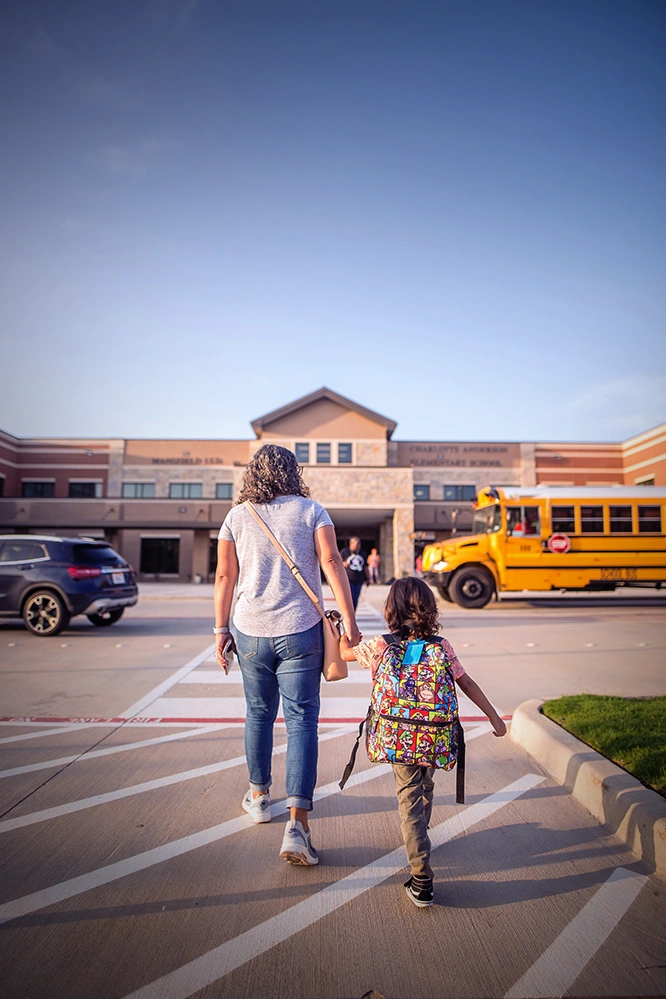 Parent walking a child to school as preserving a close relationship with the children remains an important part of working through divorce with a divorce lawyer in Rego Park