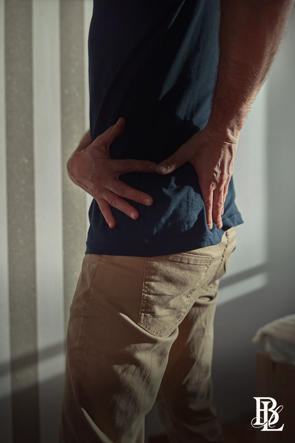 Man holding his lower back in pain after an accident