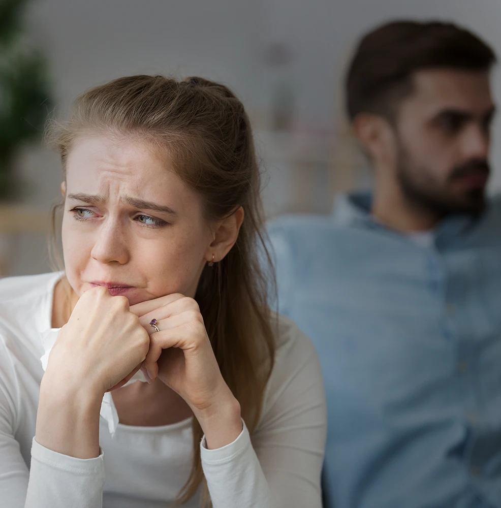 Woman sitting alone in thought while feeling uncertain about the future of her relationship