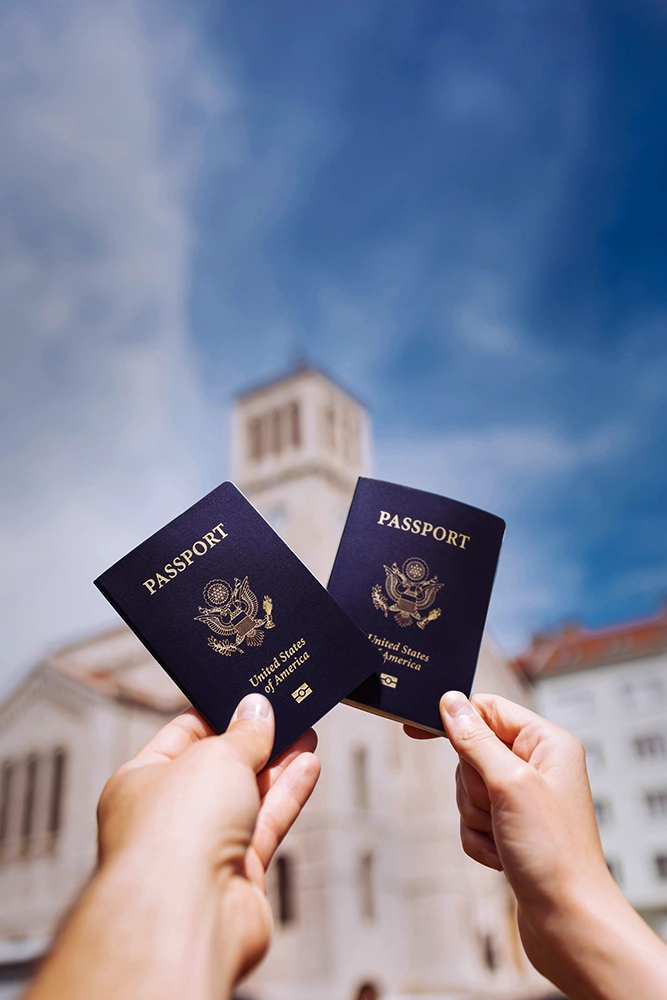 Two United States passports held up after naturalization, reflecting the next chapter a Citizenship Attorney in Rego Park can help someone work toward