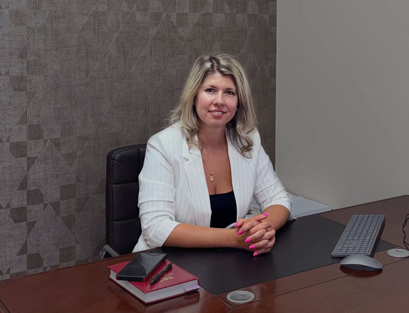 Nataliya Boyko, managing attorney of the Boyko Law Firm, seated at her desk in her office