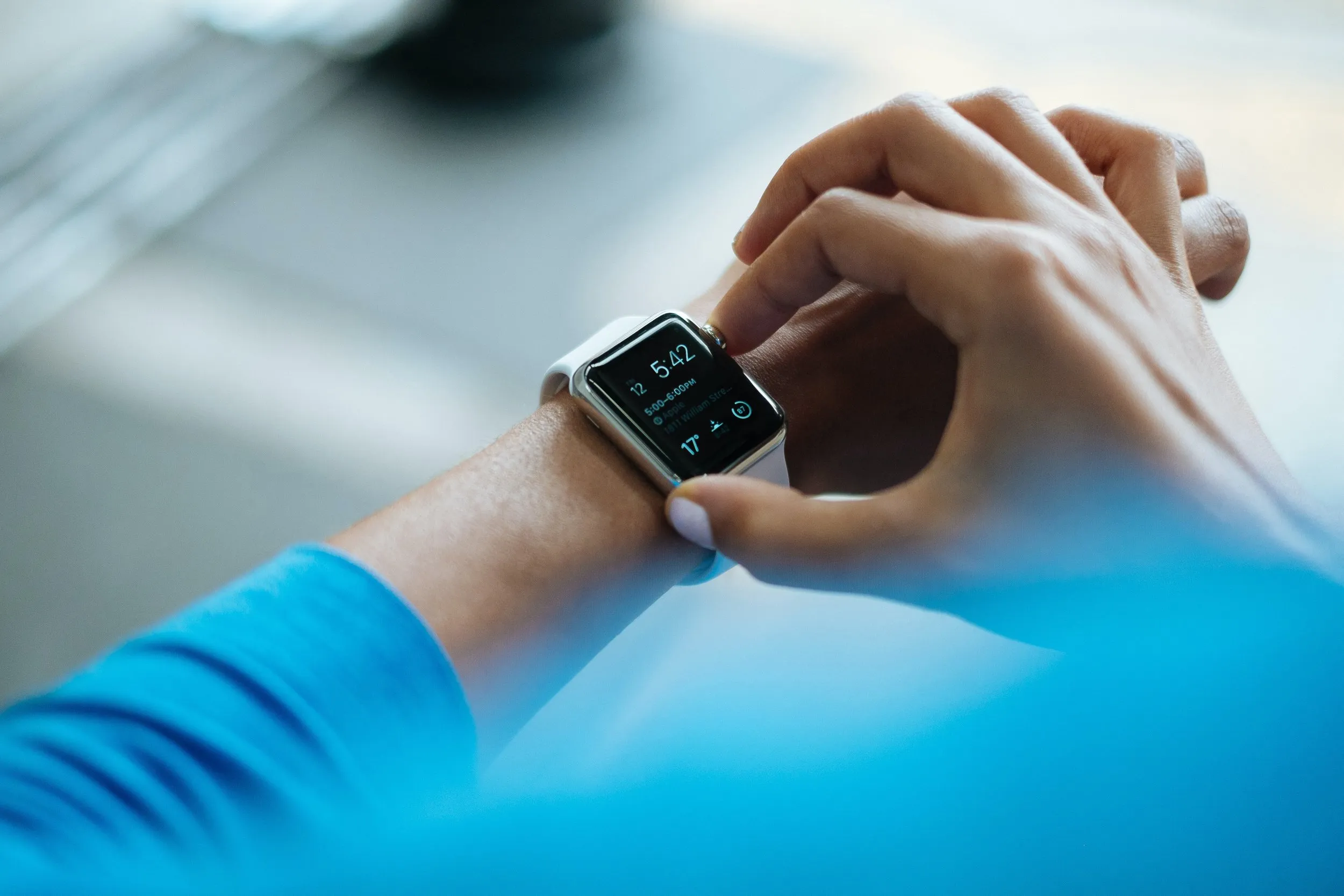Someone's hands touching their Apple Watch
