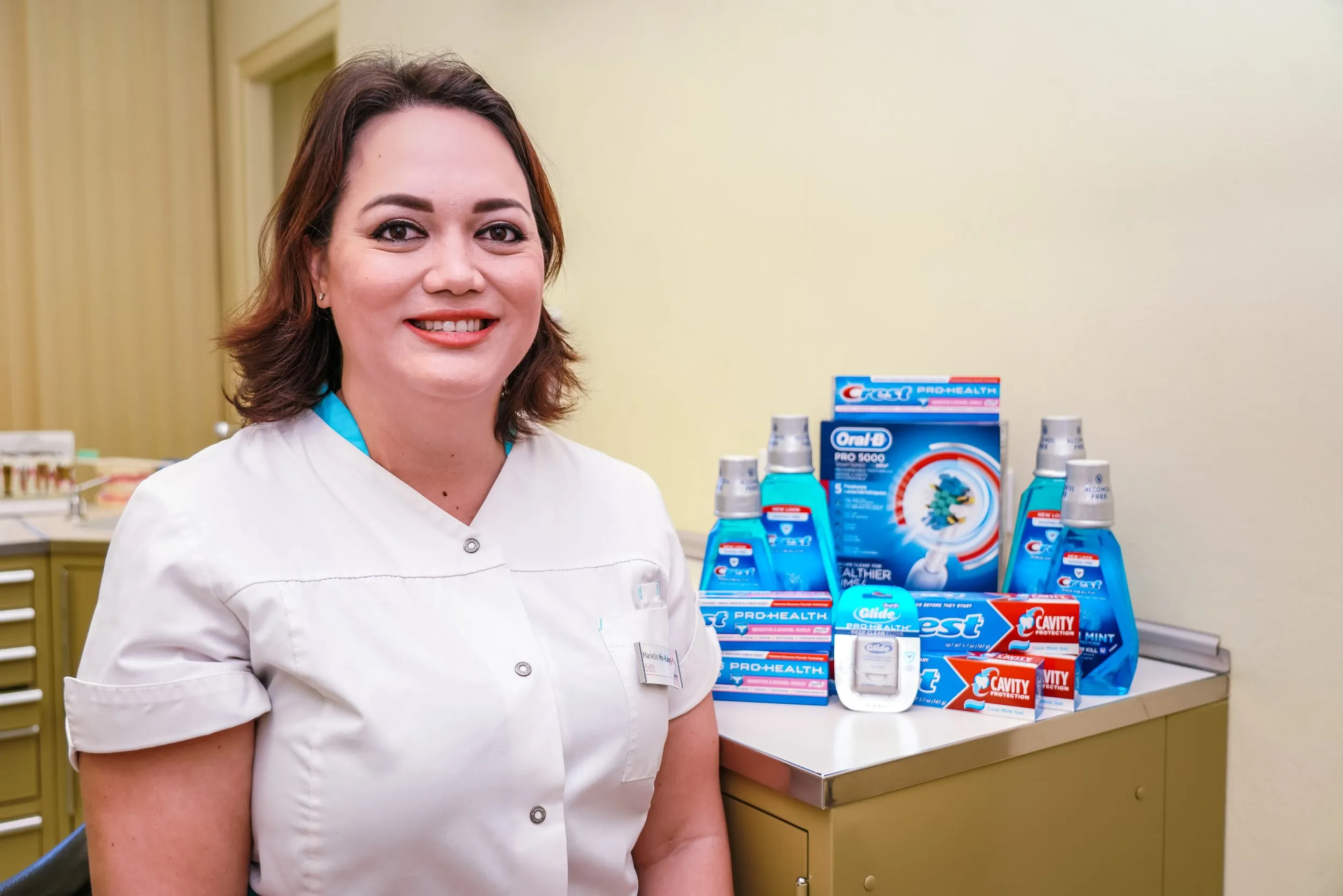 Woman standing by Crest products