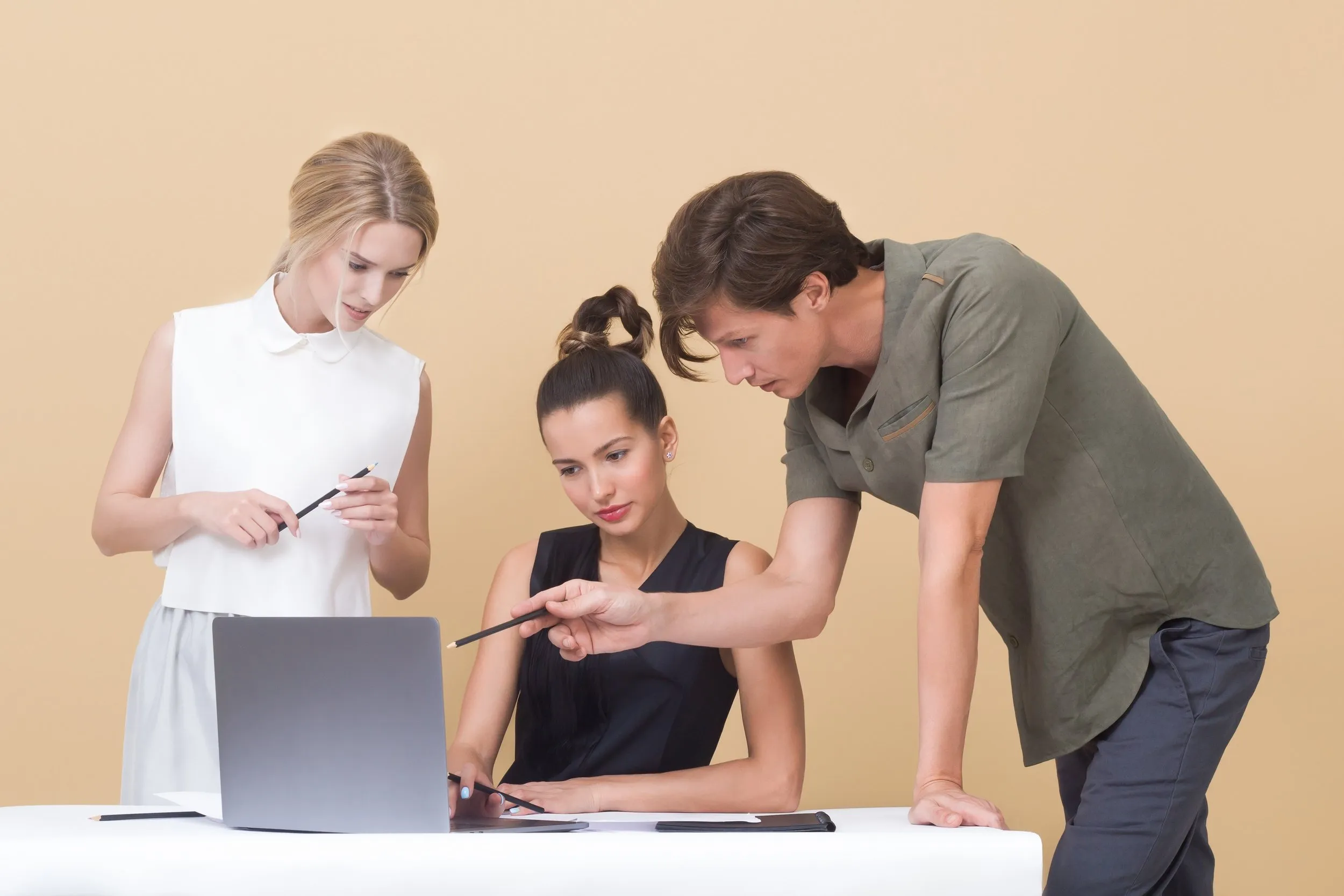 A group of people around a computer screen