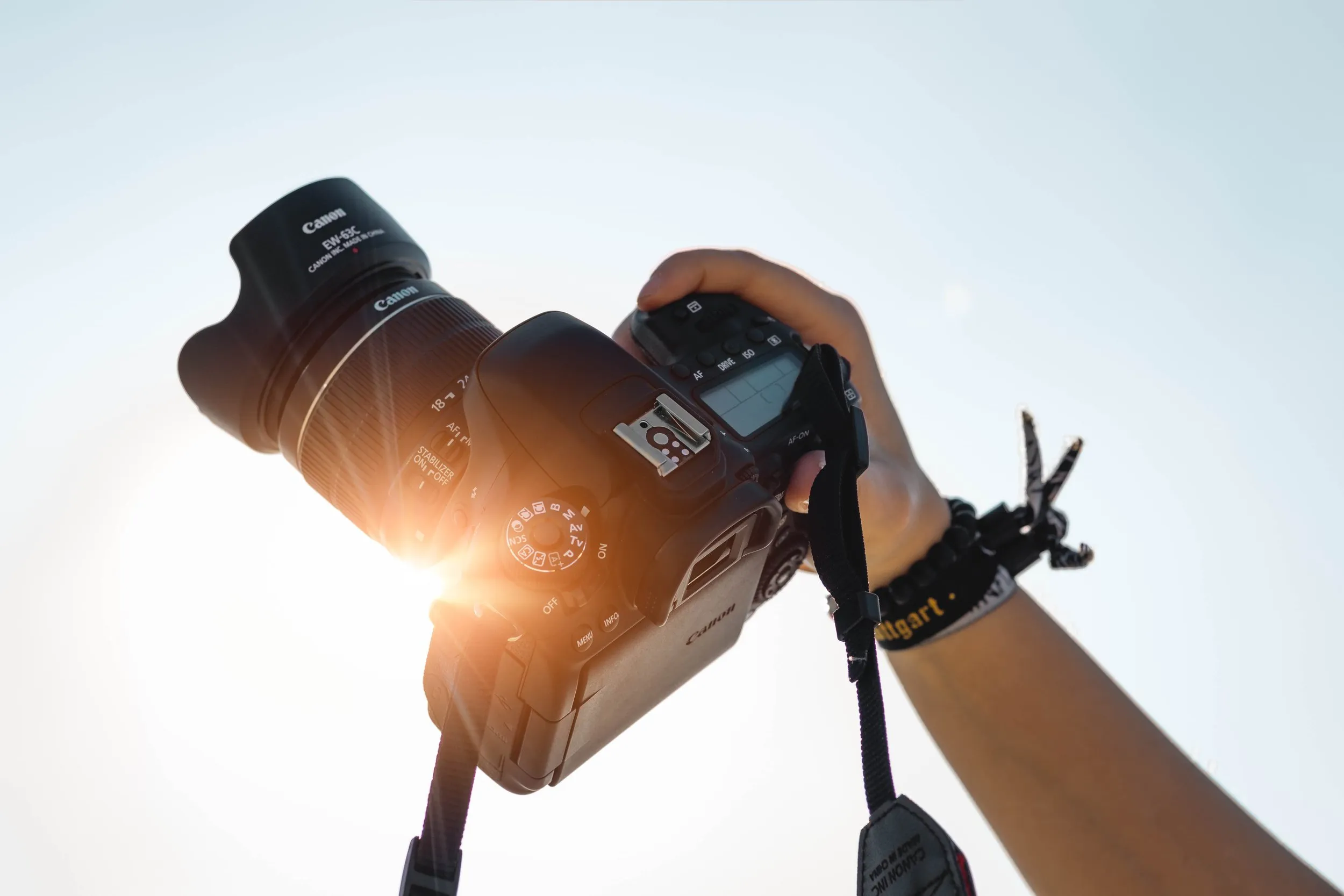 Professional camera being held up to the sky