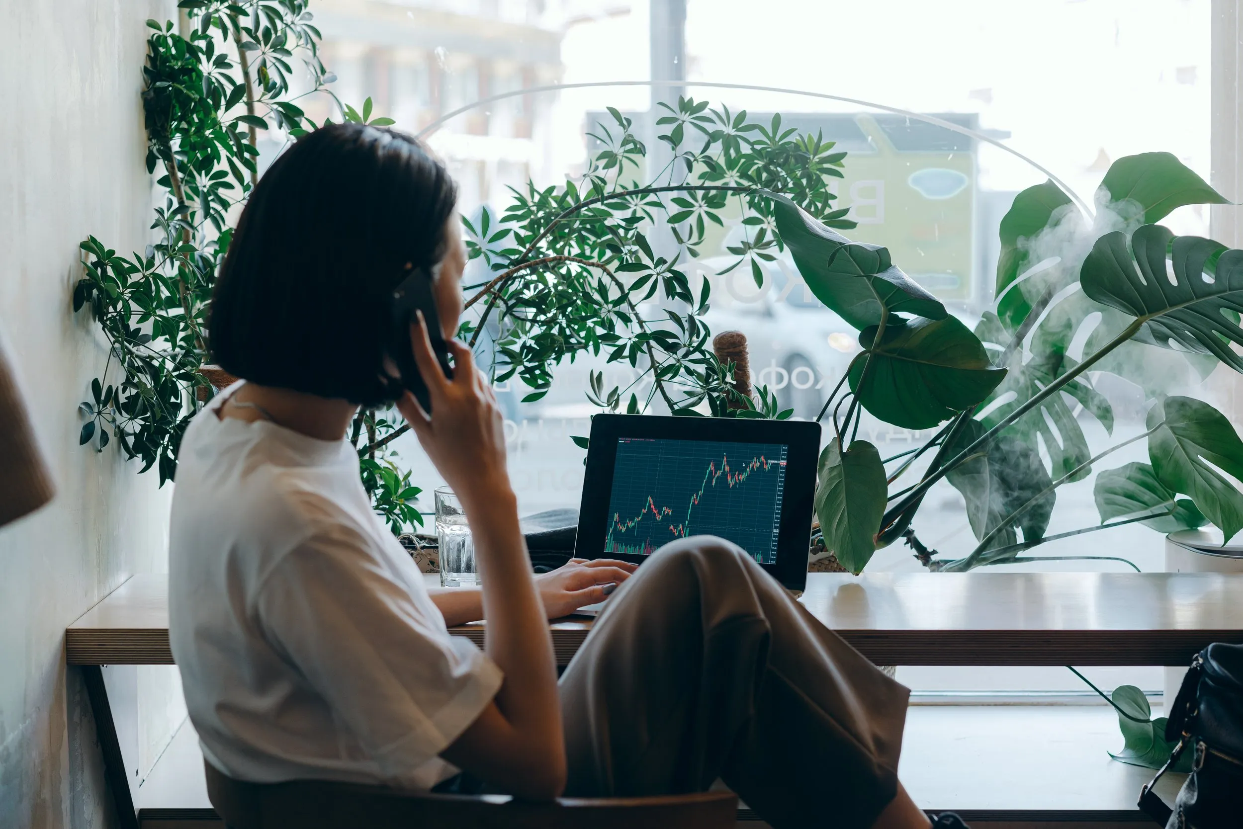 Woman looking at computer screen and on the phone