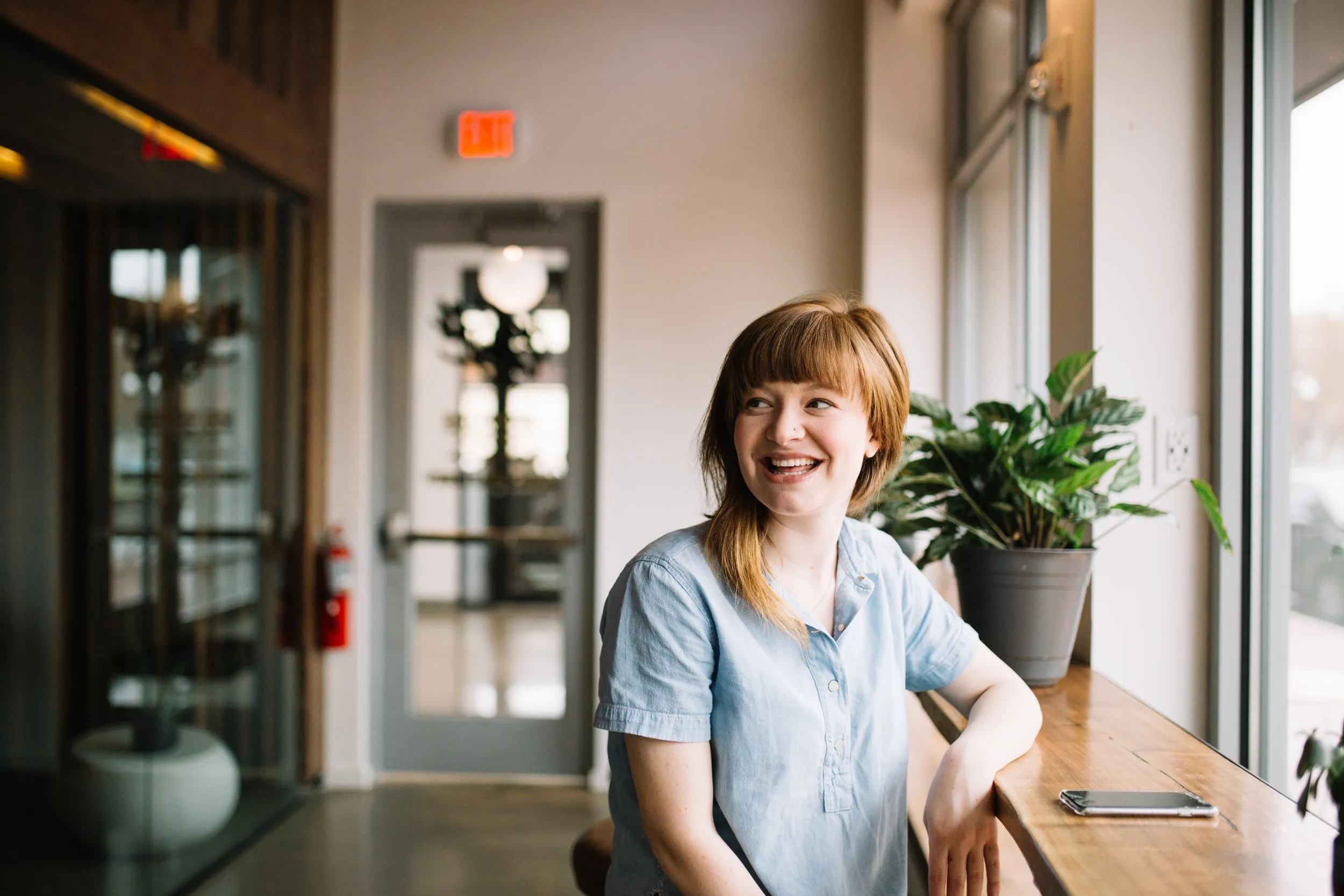 Woman smiling sitting at a counter in an office