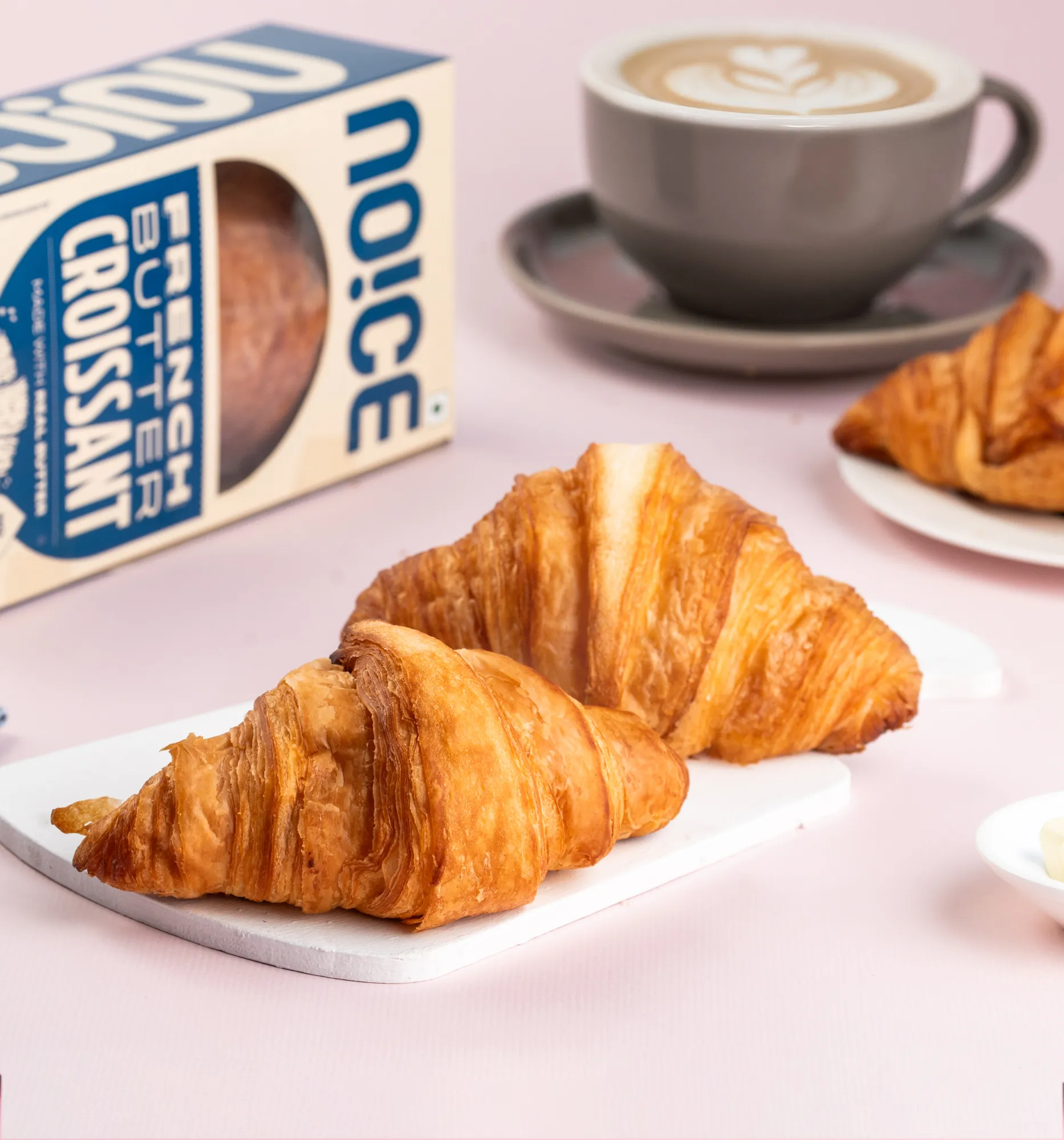 NOICE freshly made butter croissant with golden, flaky layers, handcrafted with no palm oil.