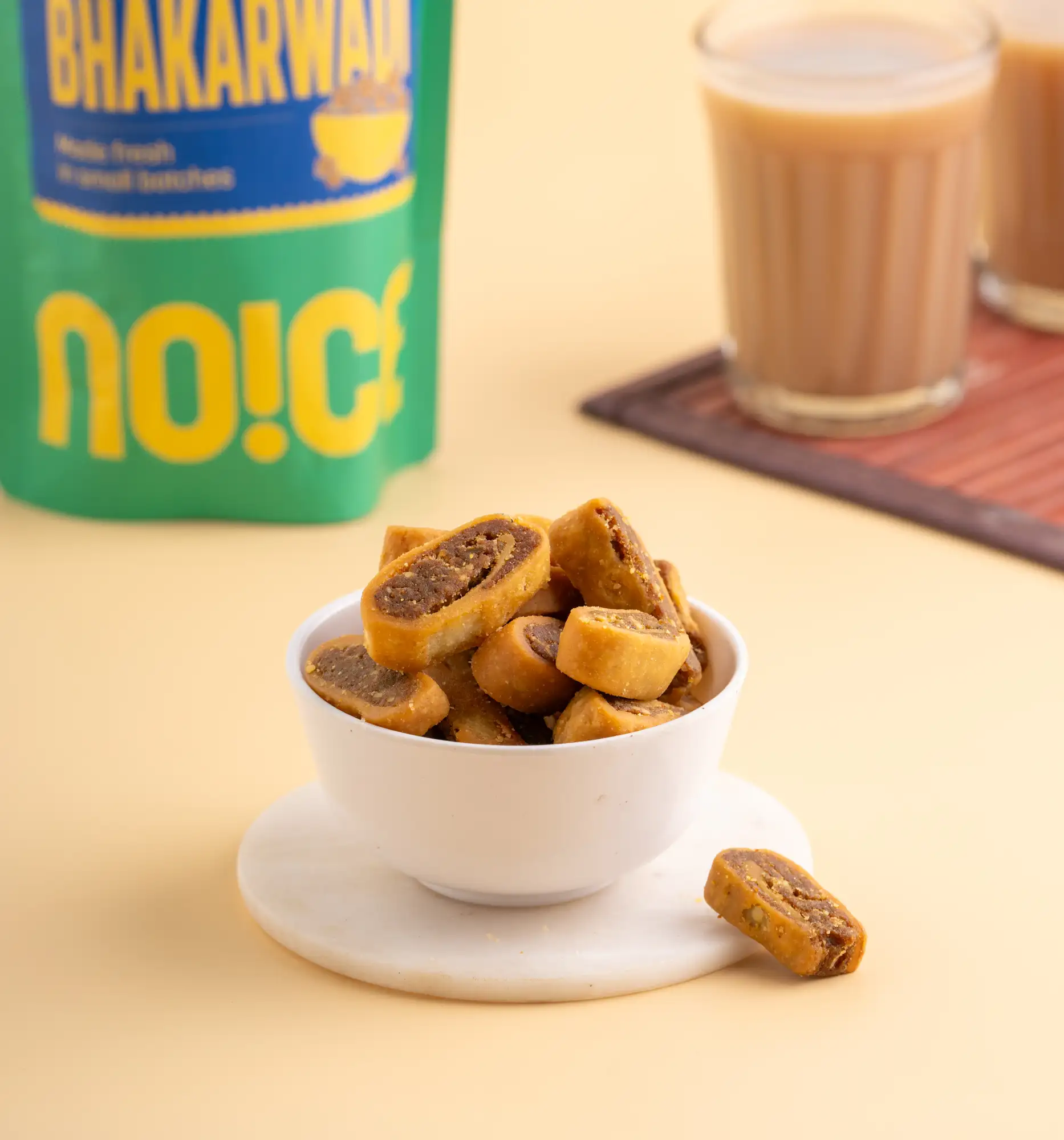 NOICE Bhakarwadi Pune Special, golden-brown spiral savory snacks with a spicy and tangy stuffing of coconut and poppy seeds, made with fresh rice bran oil