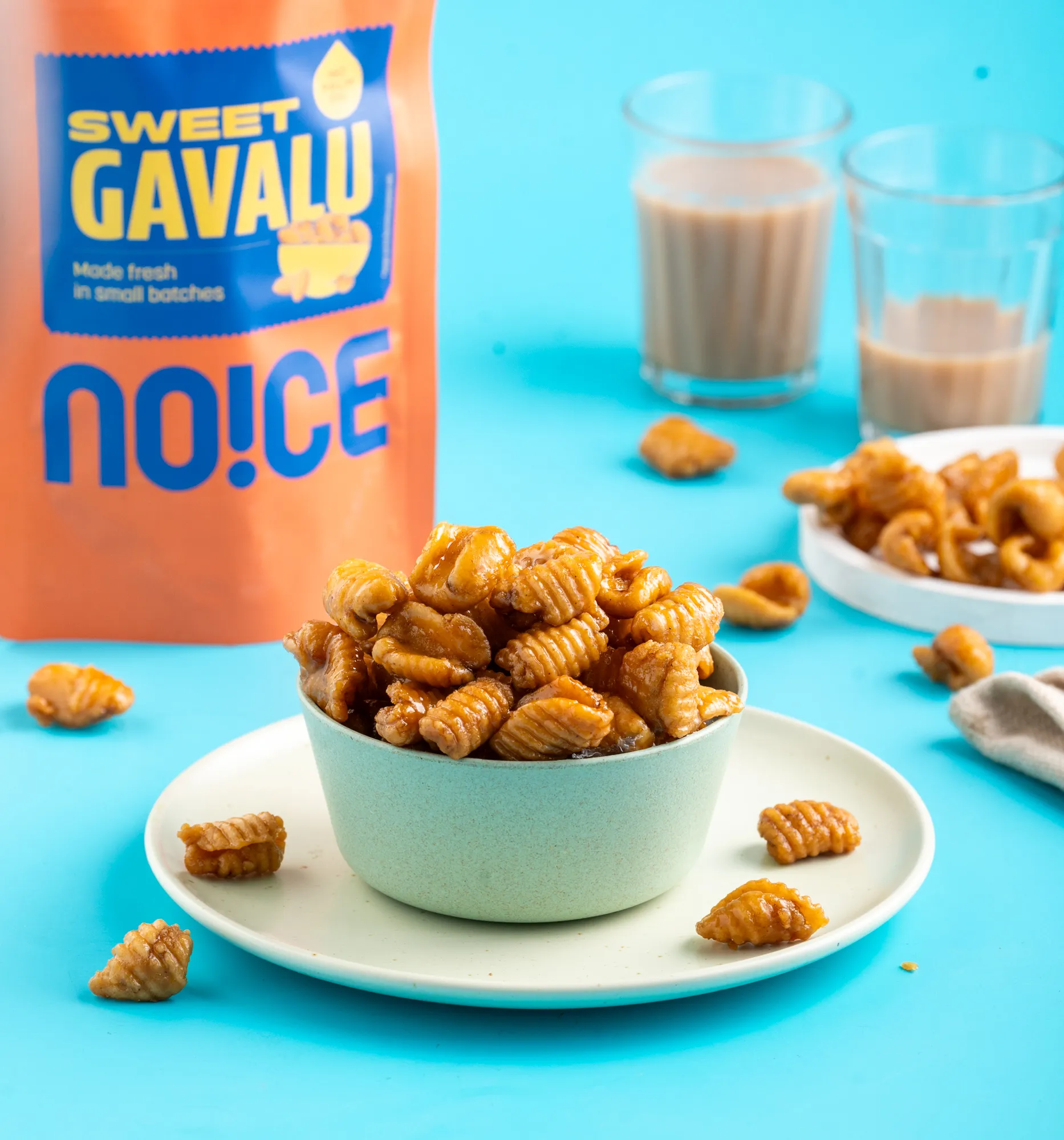 NOICE Sweet Gavvalu, golden shell-shaped flour bites coated in a crystalline sugar syrup, handmade without palm oil or preservatives