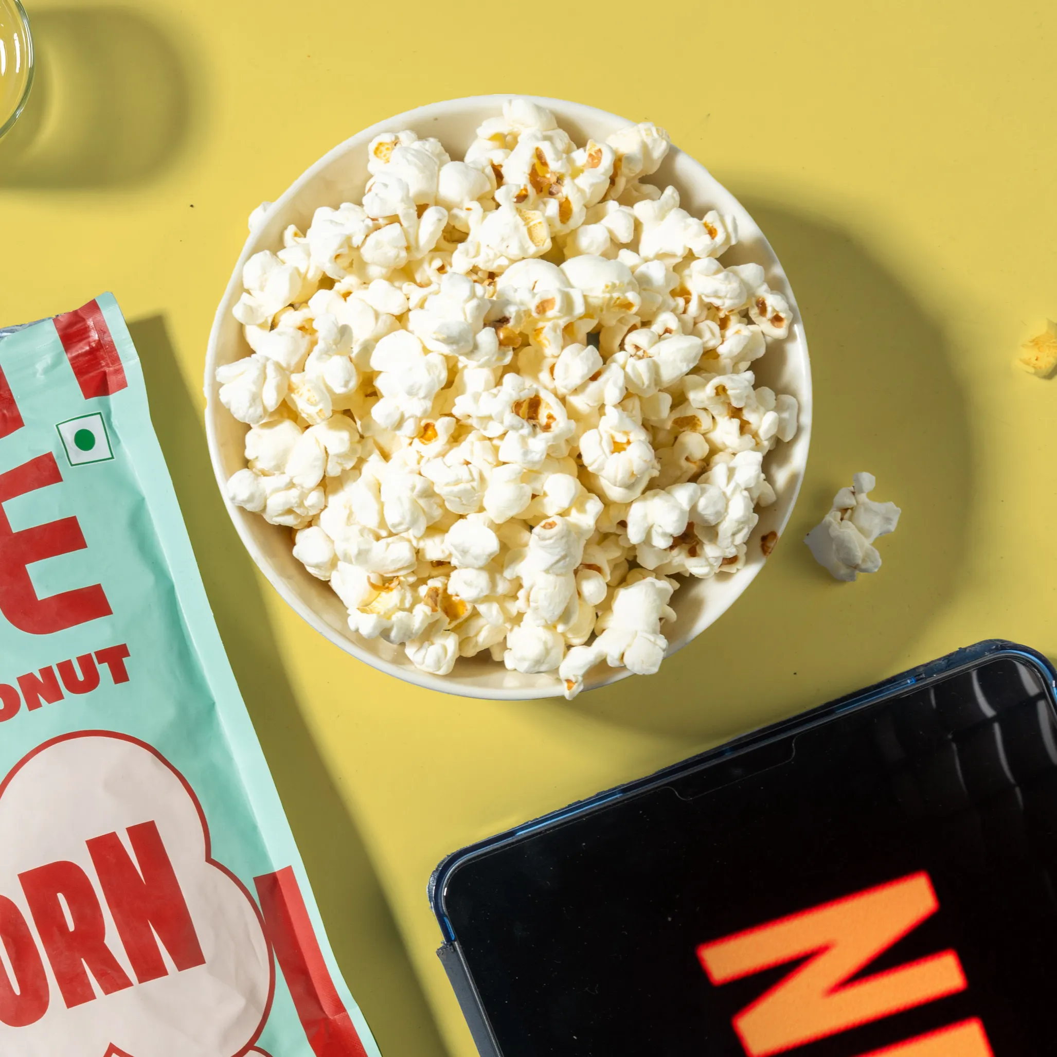 NOICE Coastal Coconut Popcorn popped in coconut oil and coated with real coconut powder, a no palm oil snack with extra crunchy texture.