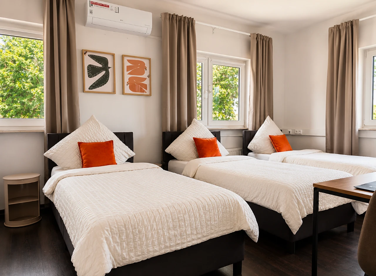 Dreibettzimmer bei BASE stay Erlangen mit gemütlichen Betten
