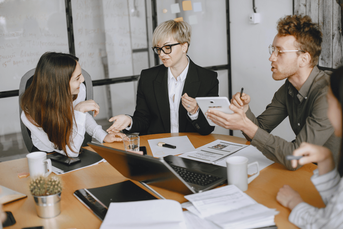 Focused group of professionals discussing over documents in a conference room.
