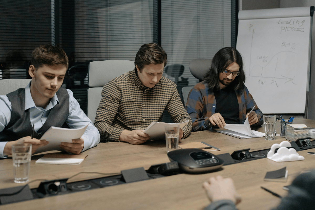 Colleagues examining paperwork during a meeting.